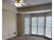 Bright bedroom featuring a window, door, and an installed ceiling fan with a light at 4508 Bankside Court, Marietta, GA 30066