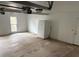 Spacious garage with stained concrete floor, garage door opener and white refrigerator at 4508 Bankside Court, Marietta, GA 30066