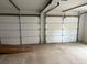 A view of an unfinished garage with two garage doors, and a concrete floor at 4508 Bankside Court, Marietta, GA 30066