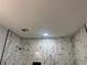 Luxurious bathroom with marble-patterned tiles, recessed lighting, and modern shower head at 684 S Hairston Rd, Stone Mountain, GA 30088