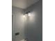 Close up of a three-light vanity fixture in a bathroom with a modern sink and mirror at 684 S Hairston Rd, Stone Mountain, GA 30088