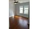 Bright bedroom with hardwood floors, ceiling fan, and natural light from several windows at 684 S Hairston Rd, Stone Mountain, GA 30088