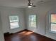 Bright bedroom featuring hardwood floors and charming arched windows with white brick trim at 684 S Hairston Rd, Stone Mountain, GA 30088