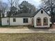 Exterior shot of the home showing driveway and yard, and unique wood trim at 684 S Hairston Rd, Stone Mountain, GA 30088