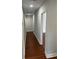 Hallway with beautiful hardwood flooring and neutral paint, leading to other rooms in the home at 684 S Hairston Rd, Stone Mountain, GA 30088