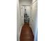 Hallway with hardwood floors leading to a utility room at 684 S Hairston Rd, Stone Mountain, GA 30088