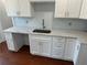 Kitchen area with stainless steel sink and white cabinets at 684 S Hairston Rd, Stone Mountain, GA 30088