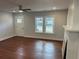 Sunlit living room with hardwood floors, ceiling fan, and freshly painted walls at 684 S Hairston Rd, Stone Mountain, GA 30088