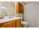 Bathroom with wooden vanity, toilet, shower, and vanity mirror at 4612 Liberty Square Dr, Acworth, GA 30101