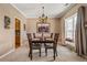 Elegant dining room with a chandelier, large window, and room for four at 4612 Liberty Square Dr, Acworth, GA 30101