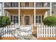 Inviting front entrance with a white picket fence, covered porch, and tasteful wreath on the door at 4612 Liberty Square Dr, Acworth, GA 30101