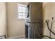 Efficient laundry room with stacked washer and dryer, maximizing space and convenience in a compact area at 4612 Liberty Square Dr, Acworth, GA 30101