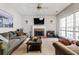 Spacious living room with a brick fireplace, ceiling fan, and ample natural light at 4612 Liberty Square Dr, Acworth, GA 30101