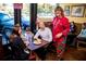 Lively restaurant with patrons enjoying a meal, featuring a chef in colorful attire and a cheerful atmosphere at 4755 Fowler St, Acworth, GA 30101