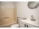 Bathroom showcasing a shower-tub combo, unique round mirror and vanity with silver hardware at 5305 Pilgrim Point Rd, Cumming, GA 30041