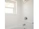 Bathroom with tile surround, shower, and window at 5305 Pilgrim Point Rd, Cumming, GA 30041