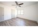 Bedroom with light gray laminate flooring, a ceiling fan, and white walls at 5305 Pilgrim Point Rd, Cumming, GA 30041