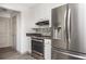 Well-lit kitchen with stainless steel appliances, mosaic backsplash, and white cabinets at 5305 Pilgrim Point Rd, Cumming, GA 30041