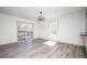 Bright living room with sliding doors leading to a deck and modern gray wood flooring at 5305 Pilgrim Point Rd, Cumming, GA 30041