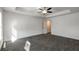 Bright primary bedroom featuring carpet and a trey ceiling with fan at 5350 Brooklands Dr, Lithonia, GA 30058