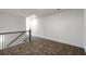 Hallway with neutral carpet and metal railing at 5350 Brooklands Dr, Lithonia, GA 30058