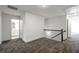 Hallway with neutral carpet and metal railing at 5350 Brooklands Dr, Lithonia, GA 30058