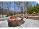 Relaxing backyard features a hot tub, fire pit with Adirondack chairs, and outdoor lounge seating at 78 Cuthbert Ln Ne, Acworth, GA 30101