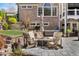 Professionally landscaped backyard features an outdoor fire pit and seating area with mature trees at 78 Cuthbert Ln Ne, Acworth, GA 30101