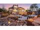 Sprawling backyard featuring a stone patio, waterfall, hot tub, outdoor furniture, and manicured landscaping at 78 Cuthbert Ln Ne, Acworth, GA 30101