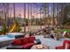 Evening view of the backyard featuring a hot tub, fire pit, patio, and professional landscaping at 78 Cuthbert Ln Ne, Acworth, GA 30101