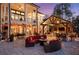 Backyard featuring an outdoor kitchen and dining area with cozy seating, a fire pit, and manicured landscaping at 78 Cuthbert Ln Ne, Acworth, GA 30101
