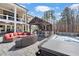 Spacious backyard has a hot tub, outdoor kitchen, lounge area, and professional landscaping at 78 Cuthbert Ln Ne, Acworth, GA 30101
