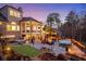Expansive backyard featuring a pool, spa, outdoor kitchen, fire pit, stone patio, and manicured landscaping at 78 Cuthbert Ln Ne, Acworth, GA 30101