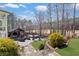 Picturesque backyard featuring an outdoor kitchen, covered patio, waterfall, and lush landscaping at 78 Cuthbert Ln Ne, Acworth, GA 30101