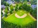 Aerial view of a well-maintained baseball field surrounded by lush trees in a residential neighborhood at 78 Cuthbert Ln Ne, Acworth, GA 30101
