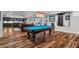 Spacious finished basement with wood floors, a pool table, and a kitchenette with stainless steel appliances at 78 Cuthbert Ln Ne, Acworth, GA 30101