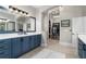 Bathroom featuring double vanity, granite countertops, large mirror, and a walk-in closet at 78 Cuthbert Ln Ne, Acworth, GA 30101