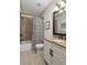Bathroom with tile shower and tub combo, vanity with granite countertop, and soft lighting at 78 Cuthbert Ln Ne, Acworth, GA 30101