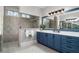 Bathroom featuring double vanity, granite countertops, large mirror, and a tiled shower at 78 Cuthbert Ln Ne, Acworth, GA 30101