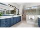 Bathroom featuring double vanity, granite countertops, large mirror, and a tiled shower at 78 Cuthbert Ln Ne, Acworth, GA 30101