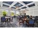 Formal dining area with large windows, coffered ceilings, and multiple tables and chairs at 78 Cuthbert Ln Ne, Acworth, GA 30101