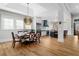 Open-concept dining area with modern lighting, a dining table with seating, and an adjacent kitchen at 78 Cuthbert Ln Ne, Acworth, GA 30101