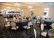 An elegant dining room with tables set with navy tablecloths, floral centerpieces, and sophisticated decor at 78 Cuthbert Ln Ne, Acworth, GA 30101