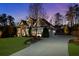 Long driveway leading to an impressive home, professionally landscaped and with exterior lighting at 78 Cuthbert Ln Ne, Acworth, GA 30101