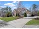 Charming home featuring well-manicured lawn, stone accents, arched windows, and a spacious driveway at 78 Cuthbert Ln Ne, Acworth, GA 30101