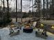 A cozy fire pit with comfortable Adirondack chairs set in a backyard with golf course views at 78 Cuthbert Ln Ne, Acworth, GA 30101