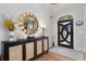 Well-lit foyer featuring hardwood floors, modern console table, decorative mirror, and a stylish front door at 78 Cuthbert Ln Ne, Acworth, GA 30101