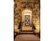 Elegant front entrance with a decorative door, stone surround, and manicured plants at 78 Cuthbert Ln Ne, Acworth, GA 30101