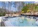 Backyard features a large hot tub, professional landscaping, and outdoor lounge area at 78 Cuthbert Ln Ne, Acworth, GA 30101