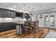 Modern kitchen with dark cabinets, granite countertops, stainless steel appliances, and seating at the kitchen island at 78 Cuthbert Ln Ne, Acworth, GA 30101